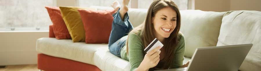Girl on couch looking at credit card offers online
