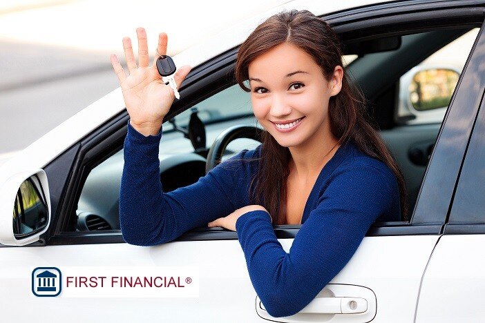 Woman with key in hand choosing auto loan provides. 