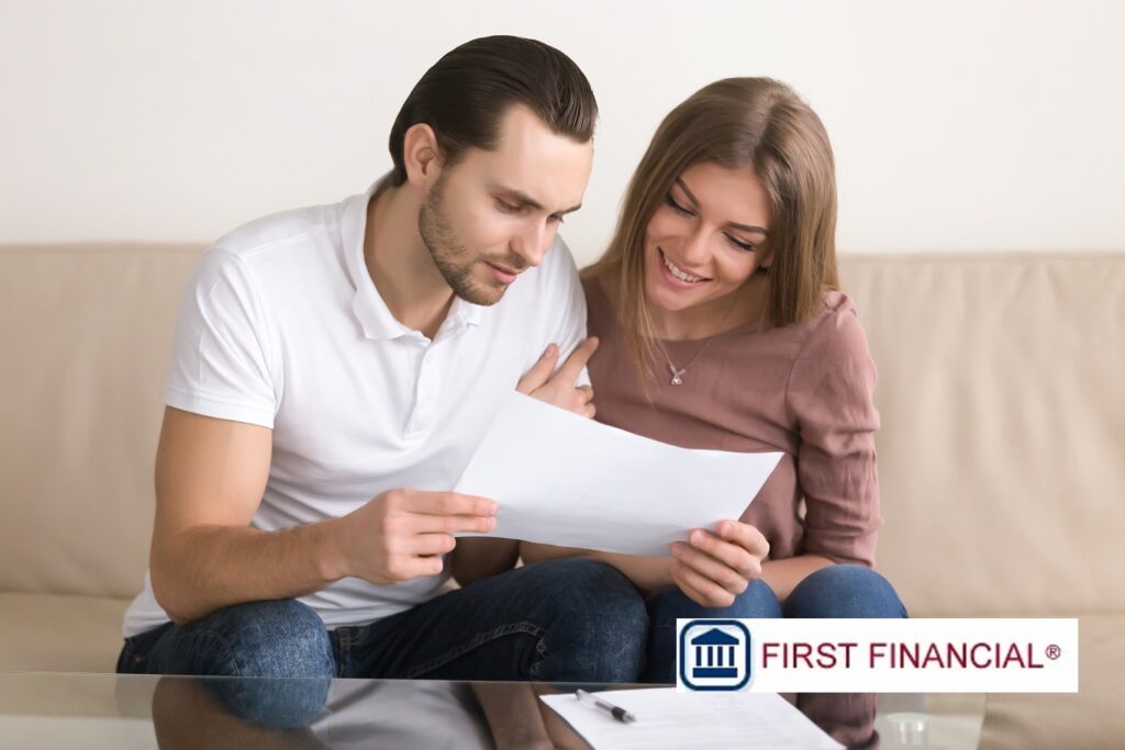 Couple looking at loan papers wondering what happens if you don't pay back a loan
